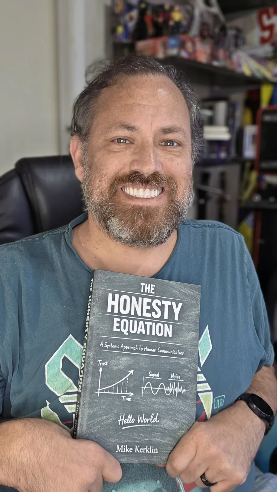 Mike Kerklin smiling, holding a copy of The Honesty Equation